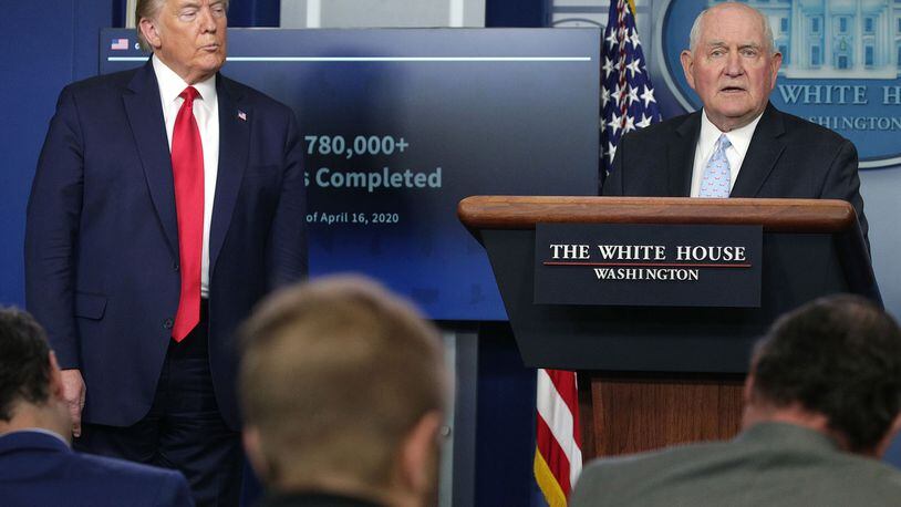 Secretary of Agriculture Sonny Perdue, right, speaks as President Donald Trump looks on during the daily briefing of the White House Coronavirus Task Force, at the White House in Washington, D.C., on Friday, April 17, 2020. (Alex Wong/Getty Images/TNS)