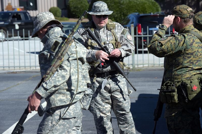 NOVEMBER 15, 2015 STONE MOUNTAIN Members of the Georgia Security Force III% militia strap up with their weapons as pro-Confederate flag supporters protest at Stone Mountain, Saturday, November 14, 2015, after a proposal was made to place a monument on top of it dedicated to Martin Luther King Jr. At noon about 50 protesters and no counter-protesters had arrived. KENT D. JOHNSON/KDJOHNSON@AJC.COM