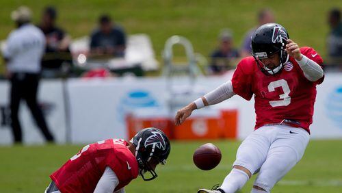 Matt Bryant (3) kicks from Atlanta Falcons punter Matt Bosher's (5) hold during training camp Wednesday.