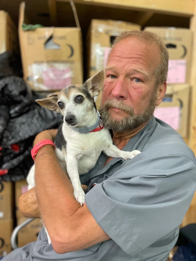 Don Bickford and his adopted dog, Maggie, pose at the East Ridge Church of Christ Benevolent Center in Chattanooga. 