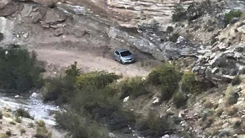 In this Oct. 2, 2017, photo released by Kane County Search and Rescue shows a vehicle driven by an older Texas couple, who were rescued severely dehydrated but alive after they were stranded six days on a desolate dirt road in southern Utah that was impassable in their rental car in the Grand Staircase-Escalante National Monument in southern Utah. The couple ended up on the rocky road Sept. 26 while following directions from a GPS-mapping app on their way to see Lake Powell. (Kane County Search and Rescue via AP)