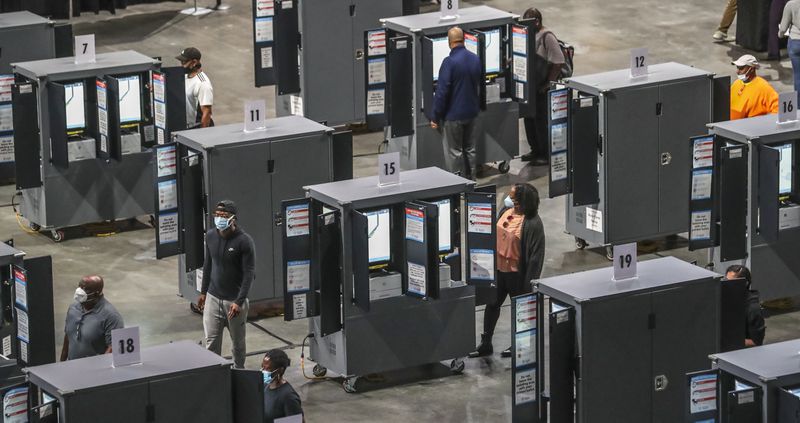 Voters finally got to the machines after a glitch forestalled voting on Monday, Oct. 12, 2020 at State Farm Arena in downtown Atlanta. (John Spink / John.Spink@ajc.com)

