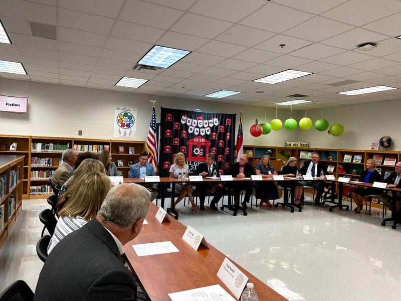 Gov. Brian Kemp (center) visited Ball Ground Elementary School in Cherokee County Friday. Next to him are his wife, Marty, and Cherokee Superintendent Brian Hightower.