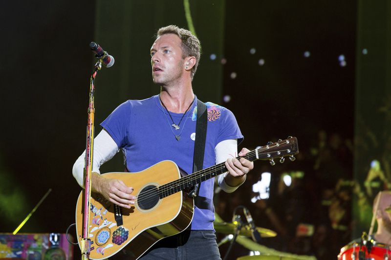 FILE - In this Sept. 4, 2016 file photo, Chris Martin of Coldplay performs at The Budweiser Made In America Festival in Philadelphia. Coldplay will join Ariana Grande at a charity concert called "One Love Manchester" in Manchester, England, Sunday, June 3, 2017, two weeks after a bomber killed 22 people at Grande's concert in Manchester. (Photo by Michael Zorn/Invision/AP, File)