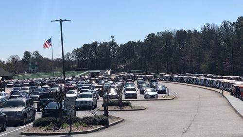 Rows of golf carts sit near a parking lot at McIntosh High School in Peachtree City. LEON STAFFORD/AJC