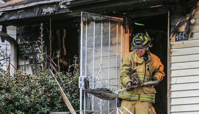 February 1, 2018 Forest Park: Forest Park firefighter, Bobby Channell on the scene where a man was killed in a Clayton Count house fire early Thursday after he rescued five children from the blaze, officials said. Neighbors called about 2:18 a.m. to report the fire at the home on Burks Road and Whitley Drive, Forest Park fire Deputy Chief Matt Jackson said. They described a chaotic scene. I heard glass breaking and I thought somebody was breaking in next door, Jacob Stewart said. John Tumlin, another neighbor, saw the man hanging the kids out the window. He wanted to help, but he said the blaze was too hot. By the time firefighters arrived, which was within minutes of the initial call, there was heavy involvement to the front of the structure, Jackson said. The five children and a woman were outside, according to officials. The children, who are between 6 and 13 years old, were taken to Southern Regional Hospital with cuts and scrapes. Theyre good kids, Stewart said. Never had any problems out of those people. The woman was taken to Grady Memorial Hospital for smoke inhalation. Stewart said she was distraught. The fire appears to have started in the living room, according to fire officials. Investigators are working to determine the exact cause and origin of the blaze, Jackson said. God bless him, Tumlin said. Hes a hero.JOHN SPINK/JSPINK@AJC.COM