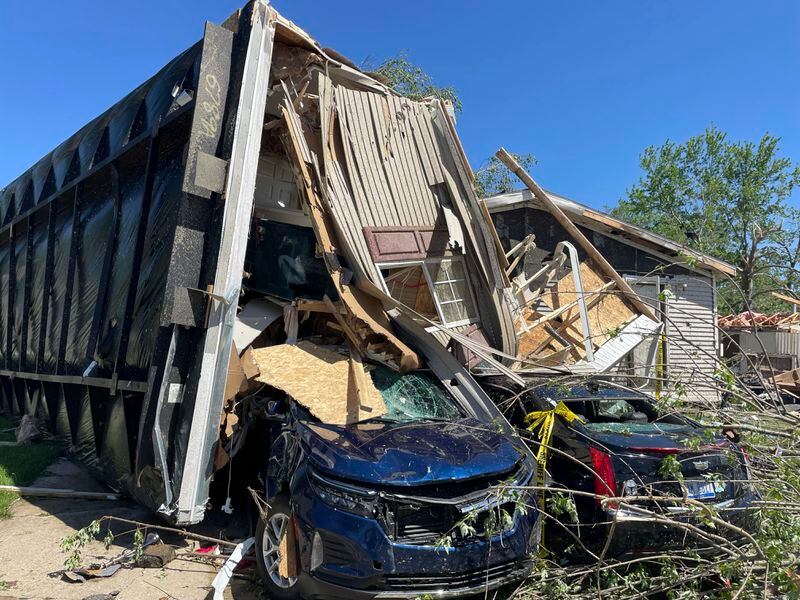 A mobile park home flipped onto two nearby cars after a tornado struck Pavilion Estates near Kalamazoo, Mich. on Wednesday, May 8, 2024. (AP Photo/Joey Cappelletti)
