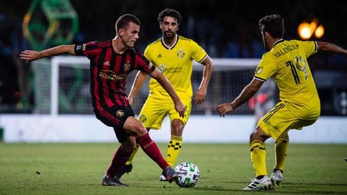 Atlanta United's Brooks Lennon attempts a move around Columbus players during 1-0 loss Tuesday, July 21, 2020, in the MLS tournament in Orlando, Fla.