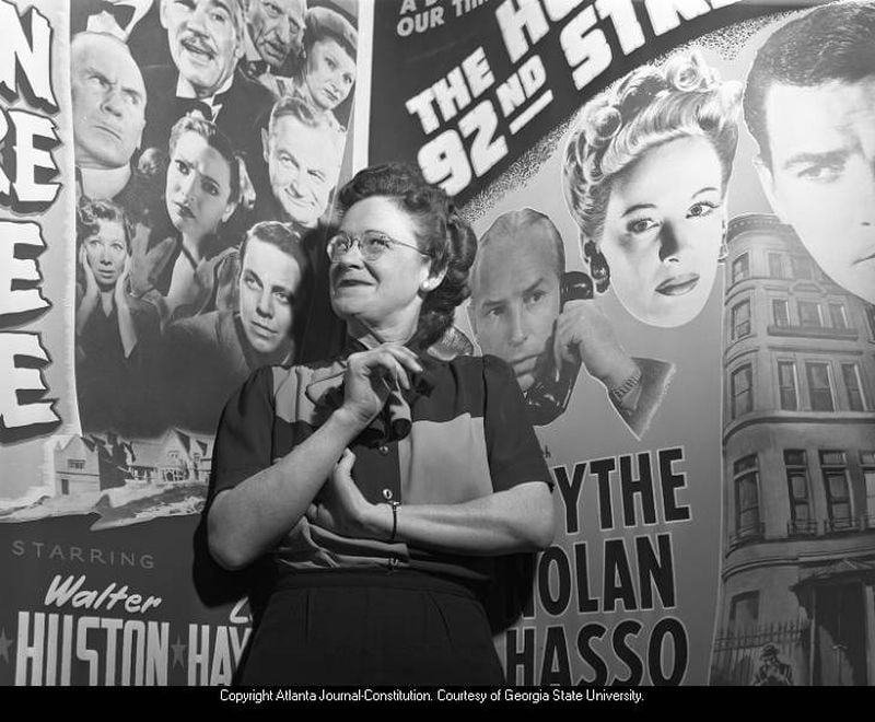 In this 1945 photo, Atlanta's official film censor, Christine Smith Gilliam, poses in front of movie posters. Gilliam held the city post from 1945 until her resignation in 1964. AJC PHOTO ARCHIVES