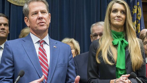 12/04/2019 -- Atlanta, Georgia -- Newly appointed U.S. Senator Kelly Loeffler (right) listens as Georgia Gov. Brian Kemp (left) speaks during a press conference in his office at the Georgia State Capitol Building, Wednesday, December 4, 2019. Georgia Gov. Brian Kemp appointed Kelly Loeffler to the U.S. Senate to take the place of U.S. Senator Johnny Isakson, who is stepping down for health reasons. (ALYSSA POINTER/ALYSSA.POINTER@AJC.COM)