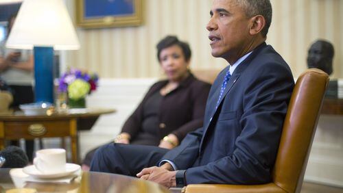 President Obama speaks about using executive power, this time related to gun control, as Attorney General Loretta Lynch listens. Not pictured: Donald Trump. (AP Photo / Pablo Martinez Monsivais)