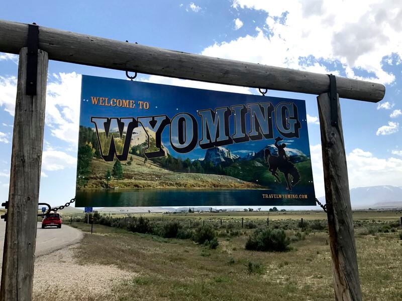 FILE - A sign on the border of Wyoming and Montana appears on the side of Belfry Highway, May 24, 2017, in Powell, Wyo. President Joe Biden will face Democratic voters this Saturday, April 13, 2024, in a pair of nominating contests in Alaska and Wyoming that are unlikely to produce any surprises. In Wyoming, Democrats will award 13 delegates using a presidential preference vote held at 23 county-level caucuses. (AP Photo/Robert Yoon, File)