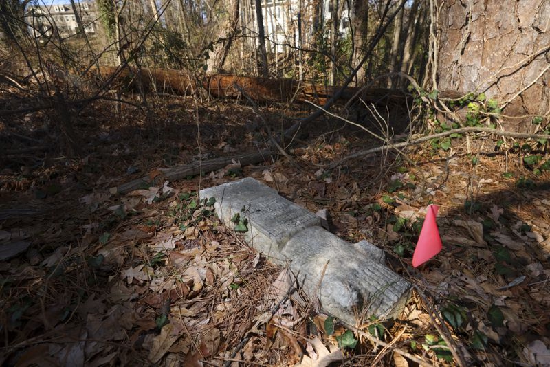 Several gravestones within the historic Piney Grove Cemetery in Buckhead have been broken, knocked over, and moved from their original location. (Jason Getz / Jason.Getz@ajc.com)