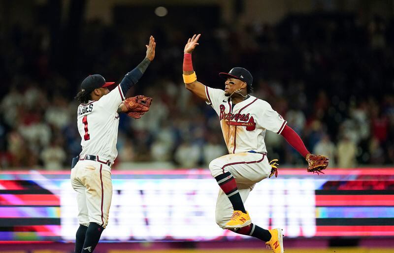 Atlanta Braves' Ozzie Albies, left, celebrates a win with Ronald Acuna Jr., right, after a game against the Los Angeles Dodgers, Saturday, June 5, 2021, in Atlanta. (AP Photo/Brynn Anderson)