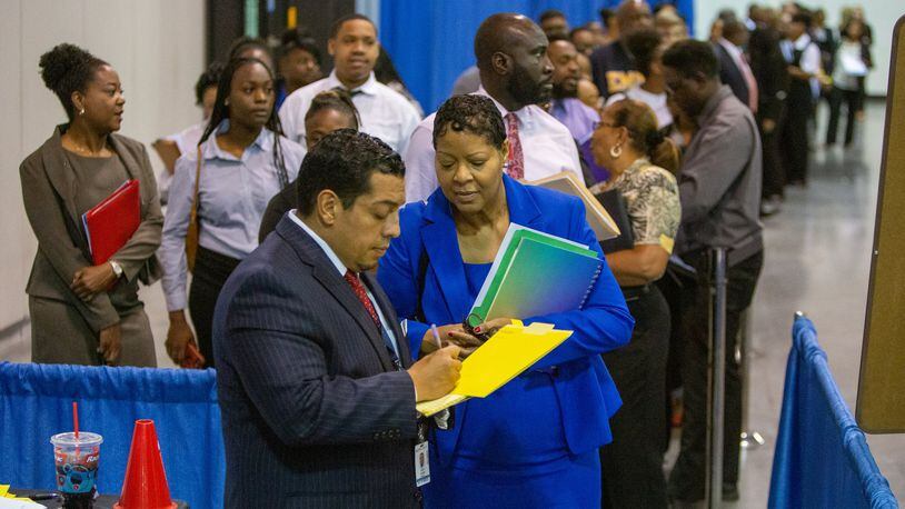 Delta Global Service hiring manager Donny Pesantes (left) talked to Karen Crawford during the Hartsfield-Jackson International Airport job fair at the Georgia International Convention Center on Tuesday, Oct. 8, 2019. The event featured more than 60 of the airport community’s top employers offering 2,000-plus jobs. (Photo by Phil Skinner for the AJC)