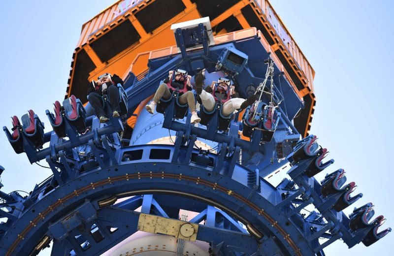 The AJC’s Tom Kelley and others ride Drop of Doom VR, a new virtual reality version of the Acrophobia drop tower, at Six Flags Over Georgia this week. On March 11, Six Flags Over Georgia will open the country’s first-ever permanent drop tower virtual reality attraction. Using Samsung Gear VR powered by Oculus, riders become the pilots of a futuristic gunship under attack by mutant spiders. HYOSUB SHIN / HSHIN@AJC.COM