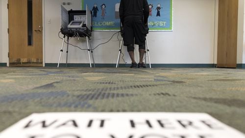 Darryl W. Smith, 51, votes at a voting station at the Southwest Branch Library in Atlanta, Georgia, on Tuesday, March 21, 2017. Residents of South Fulton voted today for mayor and city council positions. (DAVID BARNES / DAVID.BARNES@AJC.COM)