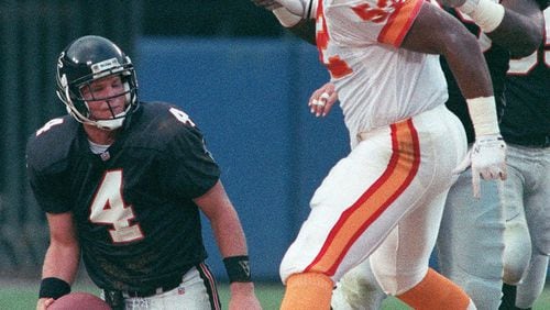 Falcons quarterback Brett Favre picks himself up rises being sacked during a 1991 preseason game against Tampa Bay. (AJC file photo)