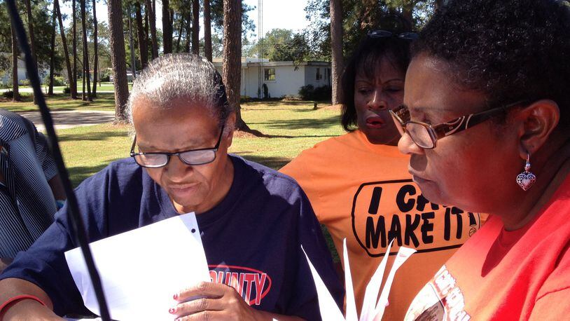 Brooks County School Board members Linda Troutman, Diane Thomas and Nancy Dennard scan maps and voter lists as they and other activists set out to campaign door-to-door in Morven, Ga. on Saturday, Oct. 4, 2014. ARIEL HART / AHART@AJC.COM