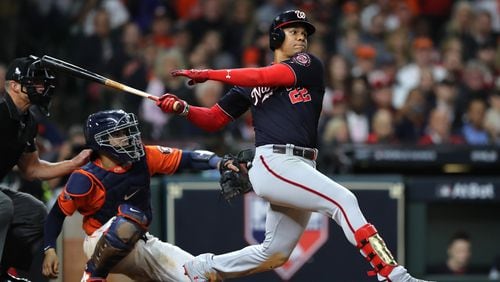Juan Soto of the Washington Nationals hits an RBI single against the Houston Astros during the eighth inning in Game Seven of the 2019 World Series at Minute Maid Park on October 30, 2019 in Houston, Texas. (Photo by Elsa/Getty Images)