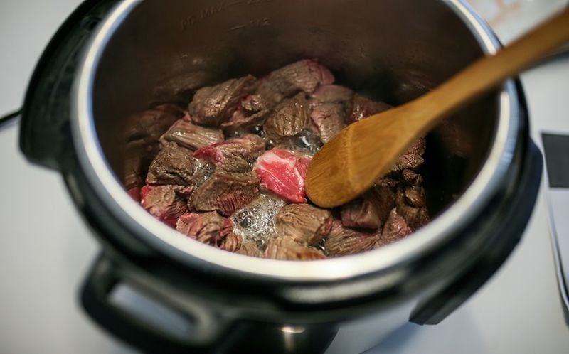 Cubes of beef are sauteed in the Instant Pot for a beef barbacoa tacos recipe. (Kimberly P. Mitchell/Detroit Free Press/TNS)