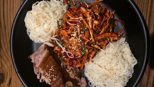 Jok Ga A Dong Chim, a Duluth restaurant specializing in pig’s feet, offers a combination platter pairing the pork (lower left) with a spicy sea-snail salad. Our critic says it’s the best thing on the menu. CONTRIBUTED BY WENDELL BROCK