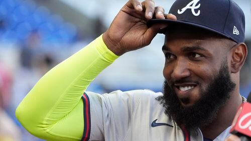 Atlanta Braves designated hitter Marcell Ozuna tips his hat to the cheering crowd as he waits to be interviewed after a baseball game against the Miami Marlins, Sunday, April 14, 2024, in Miami. (AP Photo/Wilfredo Lee)