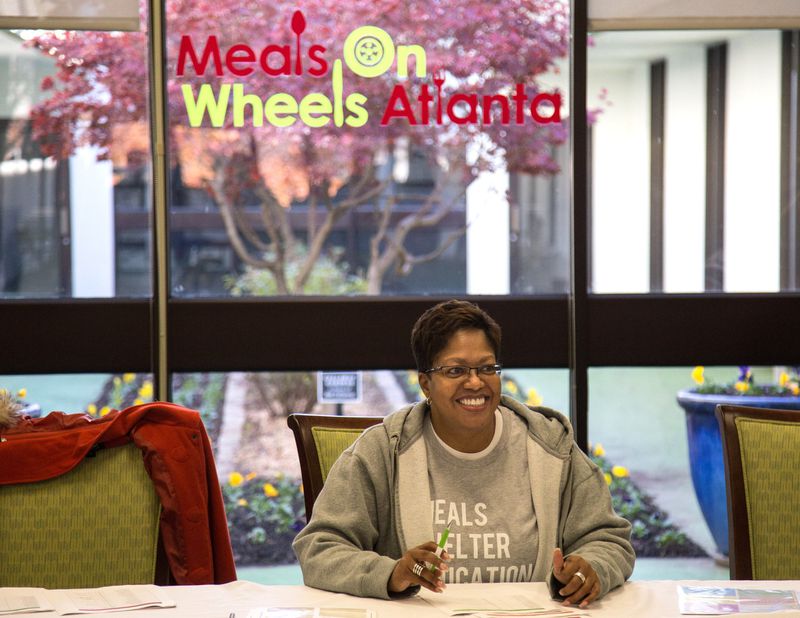 Vona Cox waits to register volunteers during a Meals On Wheels Thanksgiving meals delivery event in 2018. STEVE SCHAEFER / SPECIAL TO THE AJC