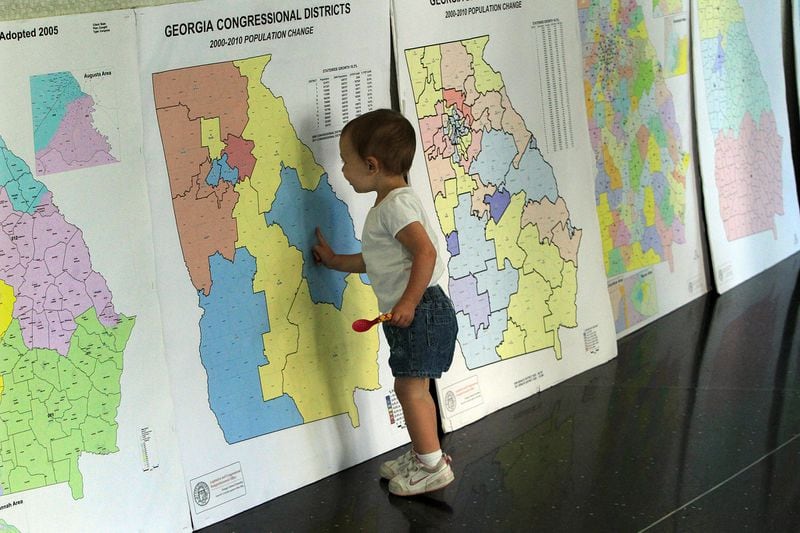A child looks over Georgia redistricting maps during a public hearing. AJC 2011 file photo