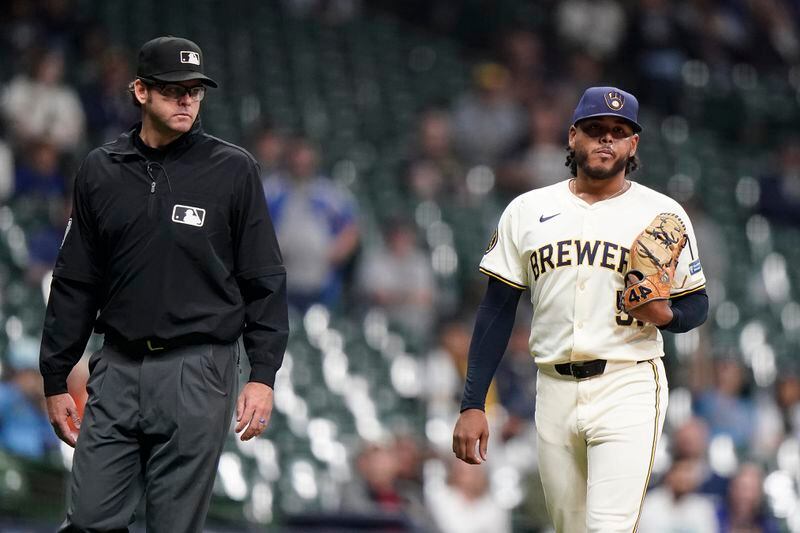 Milwaukee Brewers' Freddy Peralta, right, reacts after being ejected during the sixth inning of a baseball game against the Tampa Bay Rays Tuesday, April 30, 2024, in Milwaukee. (AP Photo/Aaron Gash)