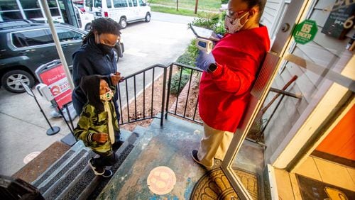 Lasharia Chambers (left) drops off her daughter Issac Gloster, 4, at the Little Ones Learning Center in Forest Park Friday morning, March 19, 2021.  (Steve Schaefer for The Atlanta Journal-Constitution)