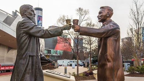 A statue of Pepsi founder Caleb Bradham, right, was delivered to the World of Coca-Cola on Wednesday and placed in front of the statue of Coca-Cola founder John Pemberton, left, as part of a promotional “cola truce” during Super Bowl week. Pepsi is an official sponsor of the Super Bowl and has placed highly visible advertising across downtown Atlanta. (Pepsi)