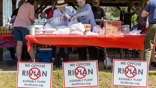 Andrea Wilson (Left) and Gail Wilson pack barbecue lunches during the Rivian Opposition Barbecue fundraiser in Rutledge Saturday, March 25, 2023.   (Steve Schaefer/steve.schaefer@ajc.com)