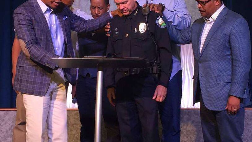 Roswell Police Department’s Chief Rusty Grant and leaders from Eagles Nest Church and Zion Missionary Baptist join for prayer following recent events, including the Dallas shooting that left five of 12 injured officers dead after a sniper opened fire during a peaceful protest against police violence on July 7, 2016.