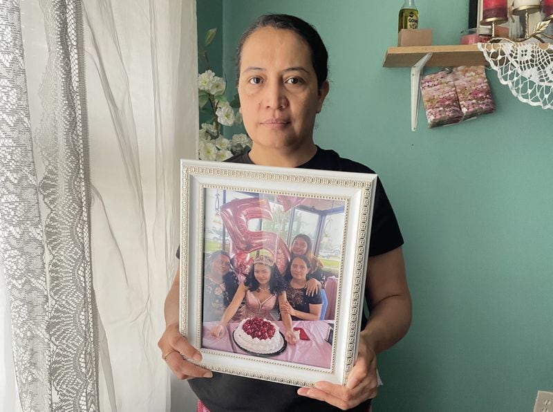 Maria Bran holds a photo of her daughter Susana Morales.