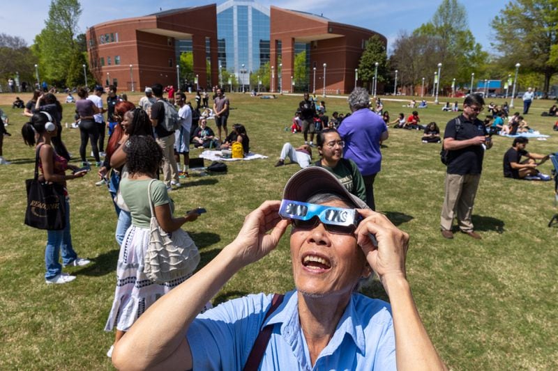 Henry Lam of Snellville watches the solar eclipse at Georgia Gwinnett College in Lawrenceville on Monday, April 8, 2024. (Arvin Temkar / arvin.temkar@ajc.com)