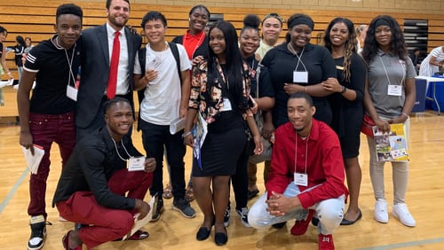 Sam Aleinikoff (second from left standing), who was a Towers High School math teacher, founded College Aim in 2013 to help DeKalb high school students navigate the college application process.  (Courtesy photo)
