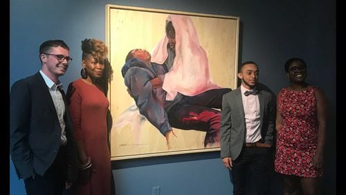Oglethorpe University student leaders stand alongside artist Shanequa Gay, (second from left) whose work "La Pieta," is the first painting in the school's art museum by an African-American female artist. The students, Brad Firchow (left), Jordan Madison (second from right) and Taylor Roberts (right) used student government association funds to buy the piece in an effort to diversify the museum's collection. ERIC STIRGUS / ESTIRGUS@AJC.COM