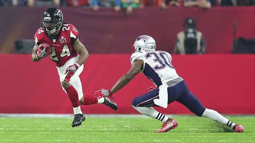 Falcons running back Devonta Freeman avoids a tackle by Duron Harmon during Super Bowl 51 at NRG Stadium Feb. 5, 2017 in Houston.
