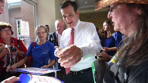 2016 GOP presidential candidate Ted Cruz autographs a sign for supporter Deb Marks (right) of Columbia, S.C., during the Georgia Republican Party State Convention in Athens in May. Hyosub Shin, hshin@ajc.com