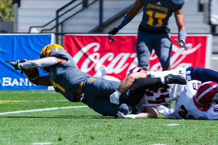 Kyle Glover dives into the end zone for Kennesaw State. CHRISTINA MATACOTTA FOR THE ATLANTA JOURNAL-CONSTITUTION.