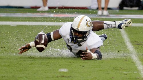 Georgia Tech running back Marcus Marshall recovers his own fumble during the second half of an NCAA college football game against Miami , Saturday, Nov. 21, 2015 in Miami Gardens, Fla. Miami defeated Georgia Tech 38-21. (AP Photo/Lynne Sladky)