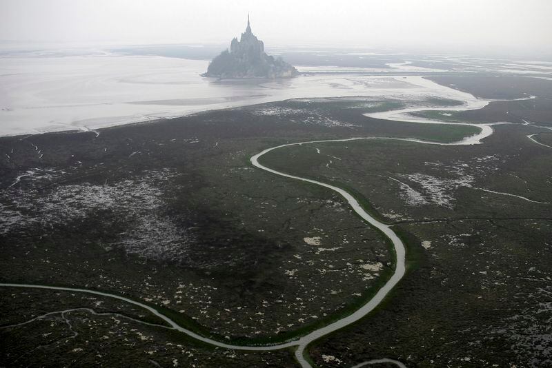 FILE - An aerial view of Mont Saint Michel, Normandy, France, March 20, 2011. The Olympic torch finally enters France when it reaches the southern seaport of Marseille on Wednesday May 8, 2024, on an armada from Greece. After leaving Marseille a vast relay route will be undertaken before the torch's odyssey ends on July 27 in Paris. A notable stop includes the stunning island of Mont-Saint-Michel. (AP Photo/David Vincent, File)