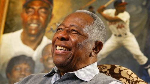 Hank Aaron smiles during a 2014 interview. The Atlanta school district will vote Monday on naming a school after the late baseball player. CURTIS COMPTON / AJC FILE PHOTO