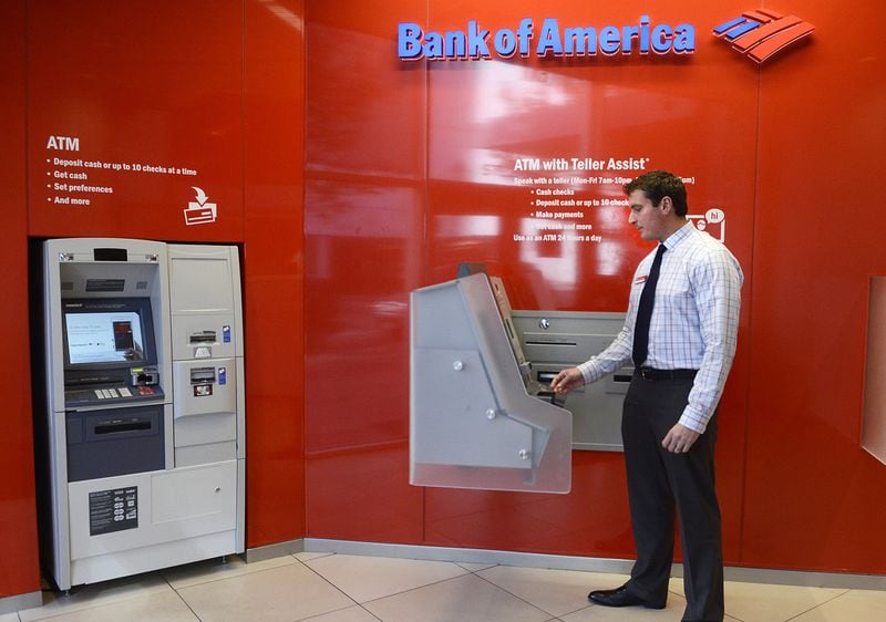 A Bank of America manager demonstrates the ATM with Teller Assist in 2015. Banks are still investing in upgrades to their ATMs, even as customers continue to do more on their mobile phones. (John D. Simmons/Charlotte Observer/TNS)