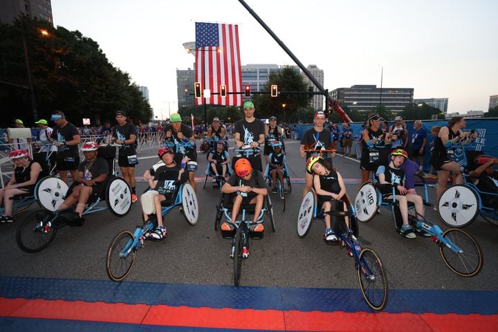 Push assist racers form up at the start of the 53rd running of the Atlanta Journal-Constitution Peachtree Road Race in Atlanta on Monday, July 4, 2022. (Jason Getz / Jason.Getz@ajc.com)