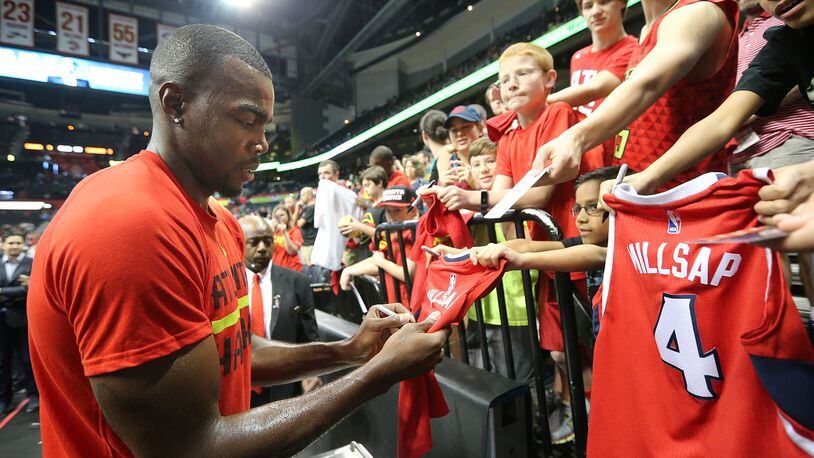 Hawks forward Paul Millsap signs autographs before playing Cleveland in Game 4 of a second-round playoff series at Philips Arena Sunday. (Curtis Compton / ccompton@ajc.com)