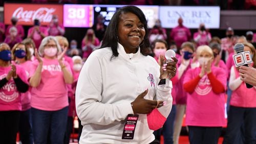 Georgia Tech associate head coach Tasha Butts acknowledges applause at Tech's game at N.C. State on Feb. 7 in Raleigh, North Carolina. Butts was honored at halftime of the game, which was a fundraiser for the Kay Yow Cancer Fund, for her own fight against breast cancer. “I never thought I’d be standing here and battling this, but you guys give me so much hope,” Butts said during the ceremony. “This game right now is against two teams, but at the end of the day, there is something more important that we’re all fighting, and there’s so much more that they’re playing this game for.” (Chris Downey/N.C. State)