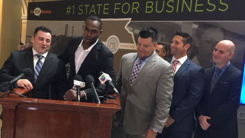 Atlanta Falcons wide receiver Julio Jones puts his arm around Guven’s Fine Jewelry founder Jon Guven during a Wednesday afternoon press conference at the Georgia State Capitol.