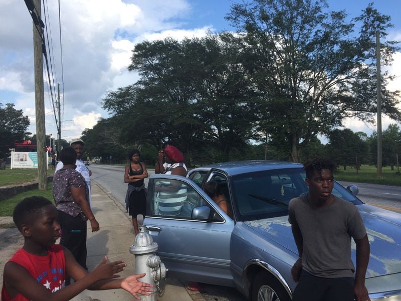 Family and friends of 18-year-old Markeith Oliver await information as they gather on Martin Luther King Jr. Drive SW in July 2017.